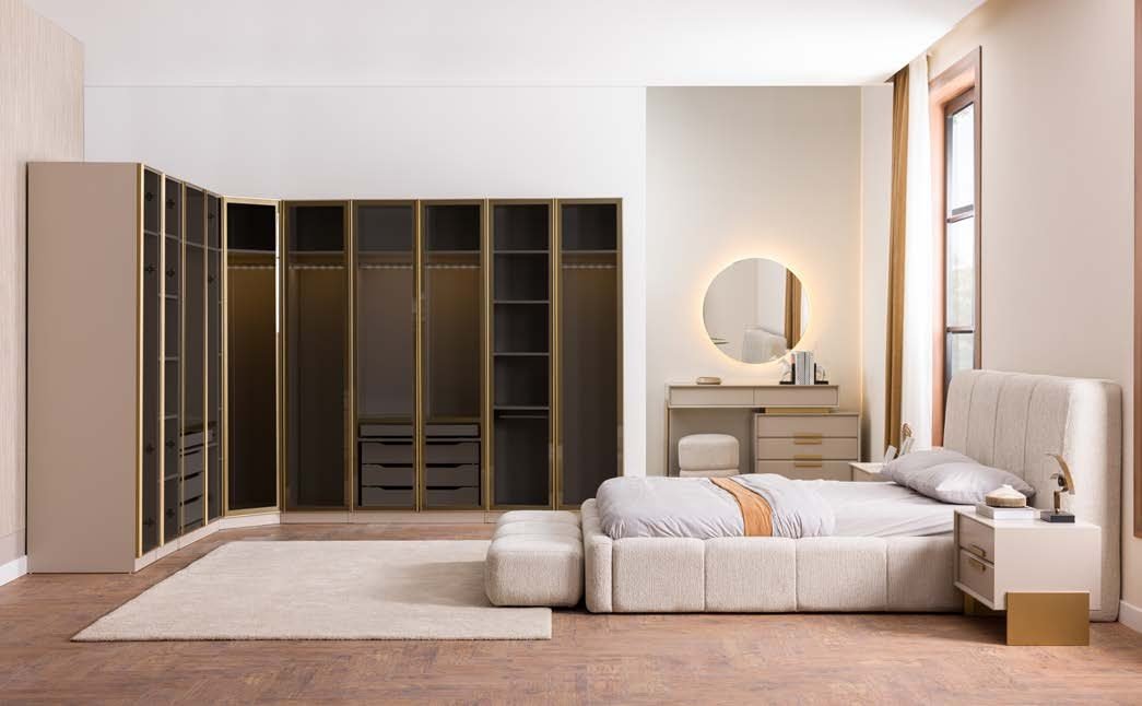 Dressing modular Gala pe colț, cu uși de sticlă fumurie în rame aurii, interior iluminat, pat crem și oglindă rotundă